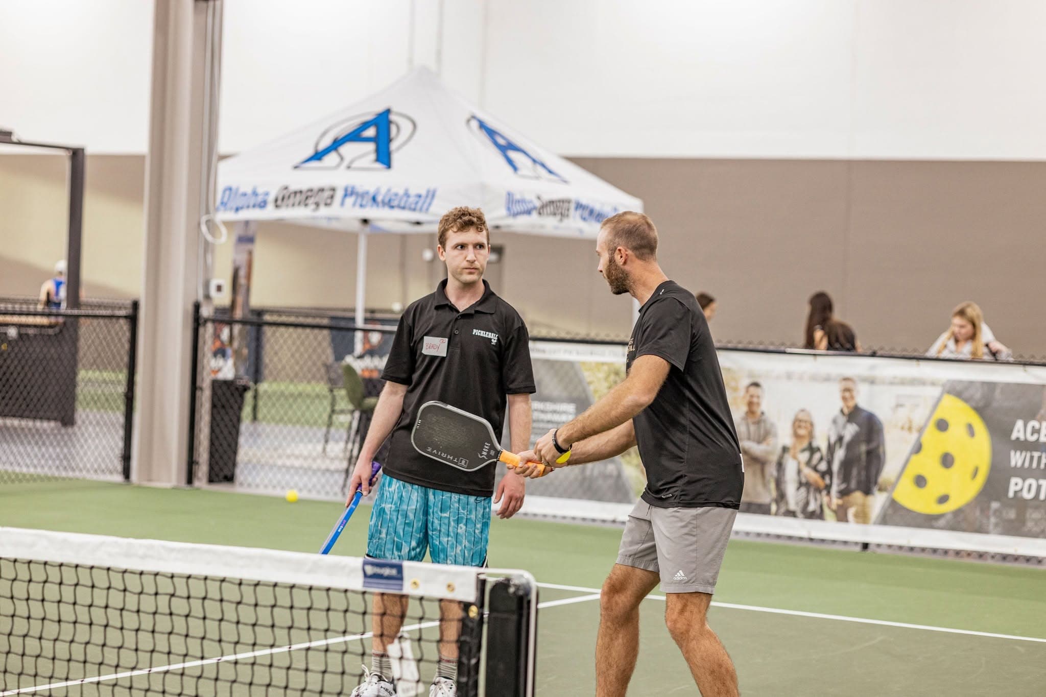 Coach working with a player on court