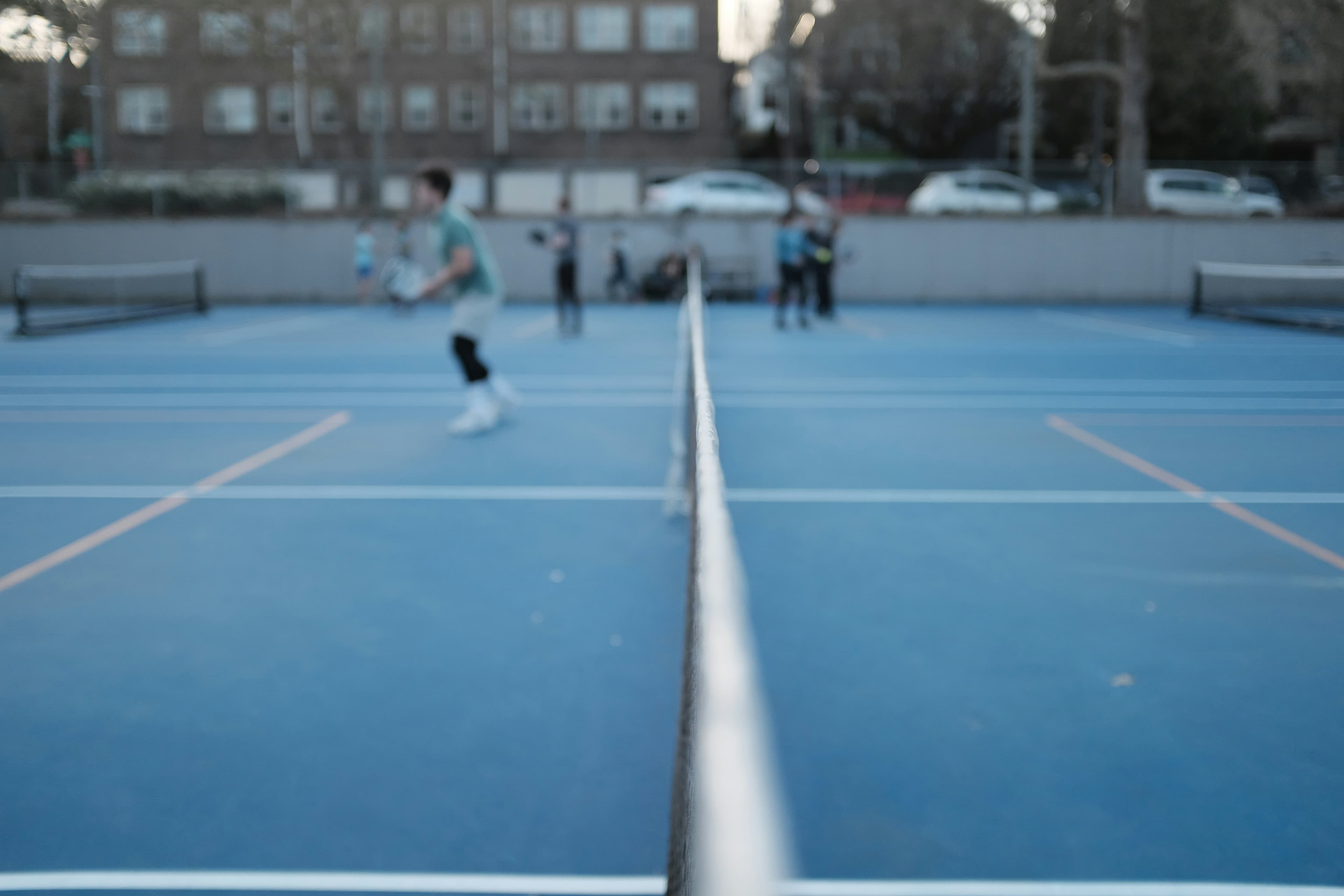 Pickleball court with blue surface and white net